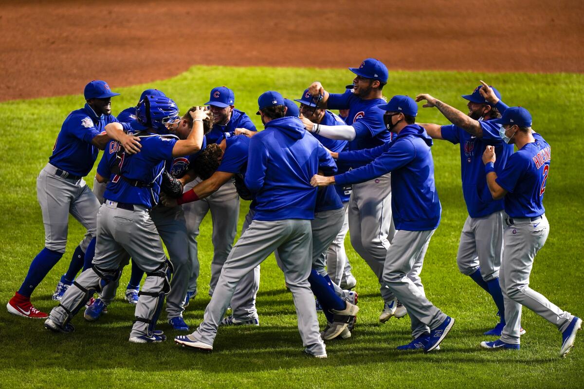 Chicago Cubs pitcher Alec Mills is swarmed by his teammates after throwing a no-hitter against the Milwaukee Brewers.