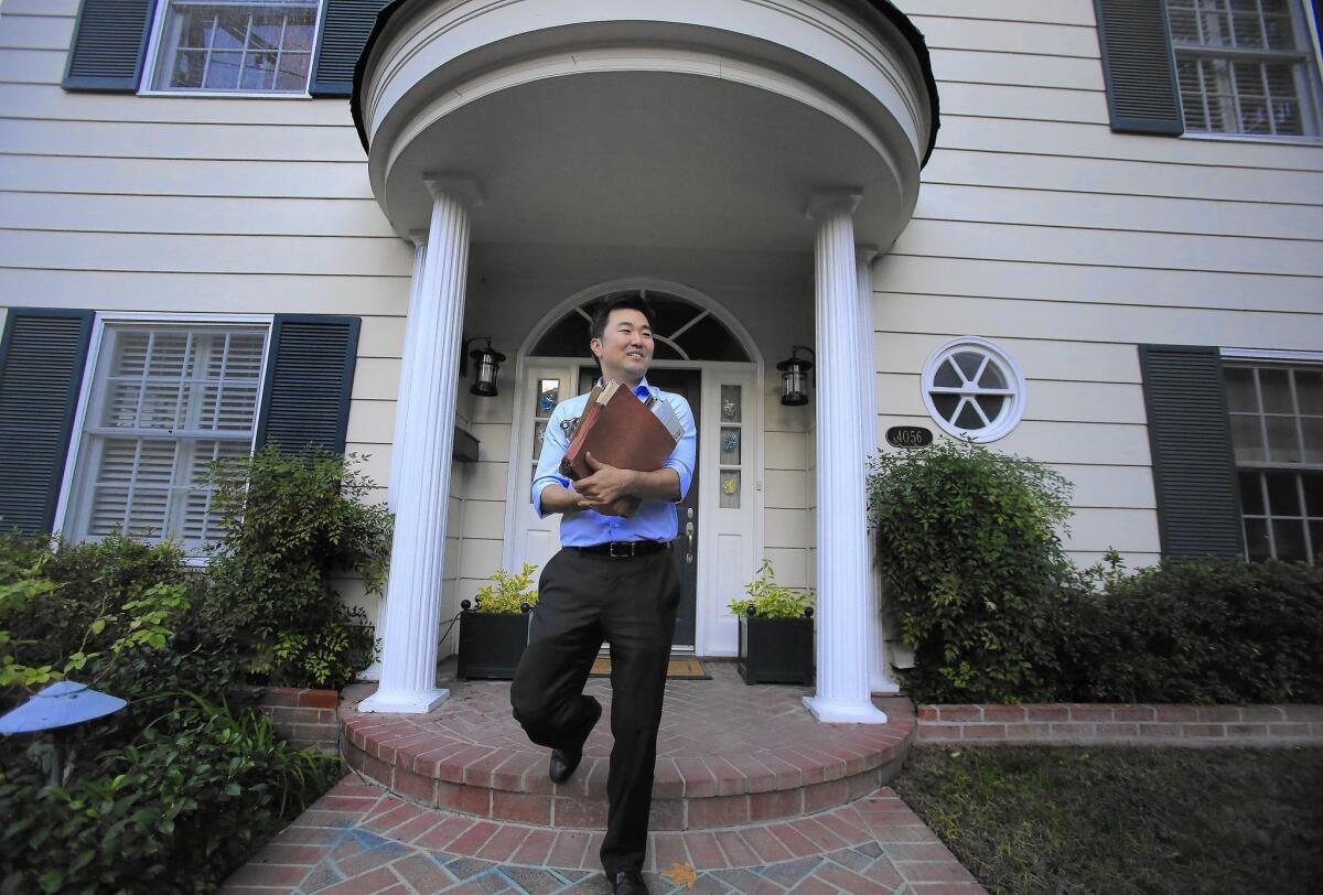 City Council candidate David Ryu leaves a home after visiting the homeowner in Sherman Oaks. Ryu has raised about $265,000, more than any of his rivals.