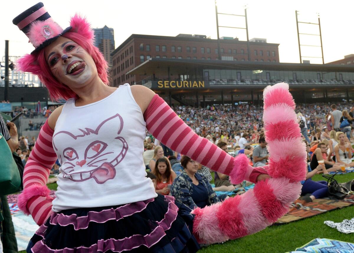 Christine Keller, dressed as the Cheshire Cat, was one of 13,000 attendees at the Walker Art Center's Internet Cat Video Festival at CHS Field in St. Paul, Minn, on Aug. 12, 2015. Organizers of CatConLA say the touring Catvidfest will screen locally in late June 2016.