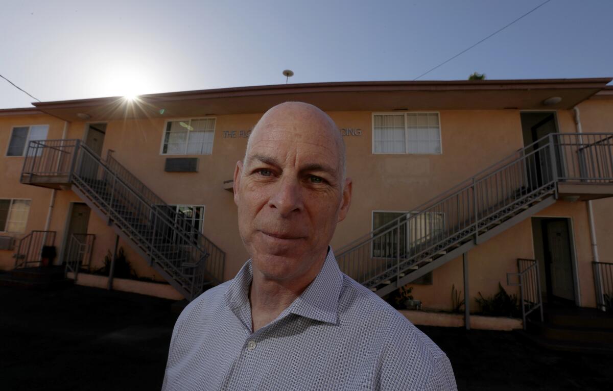 Tod Lipka stands outside a motel.