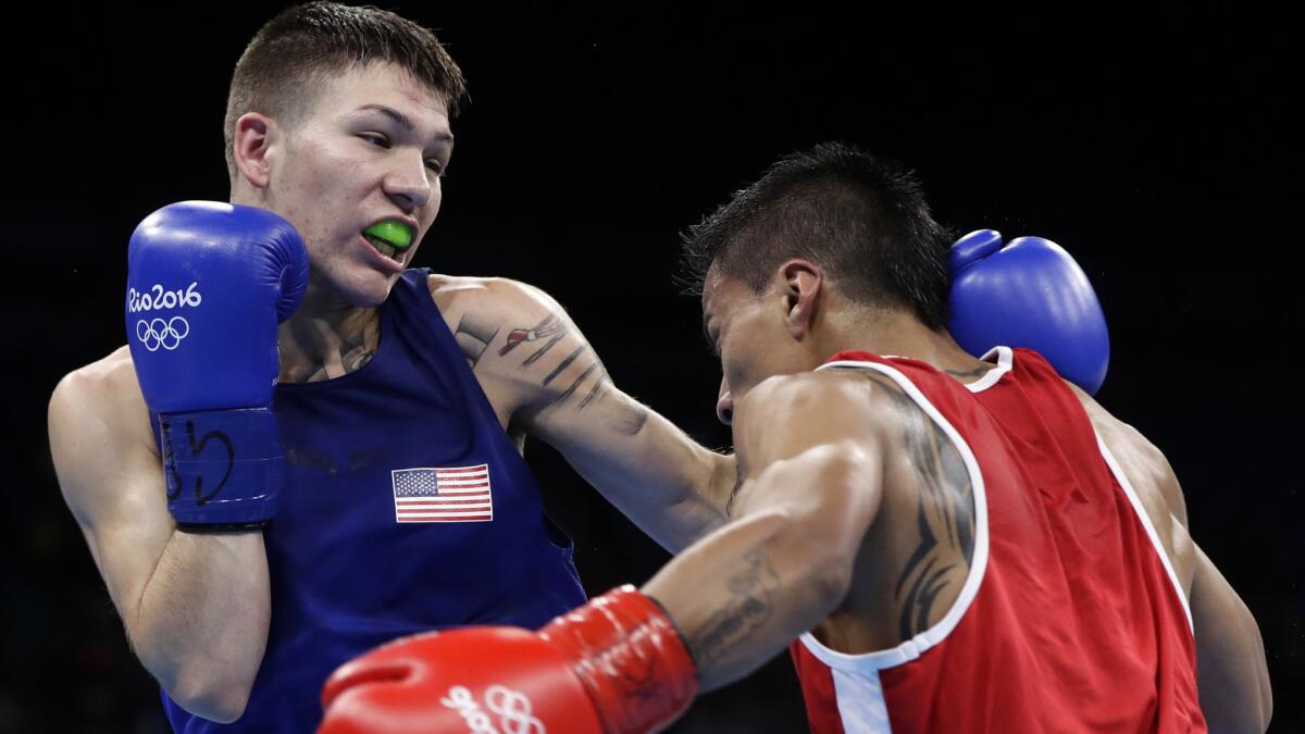 American boxer Nico Hernandez exchanges punches with Ecuador's Carlos Quipo during their bout Wednesday.
