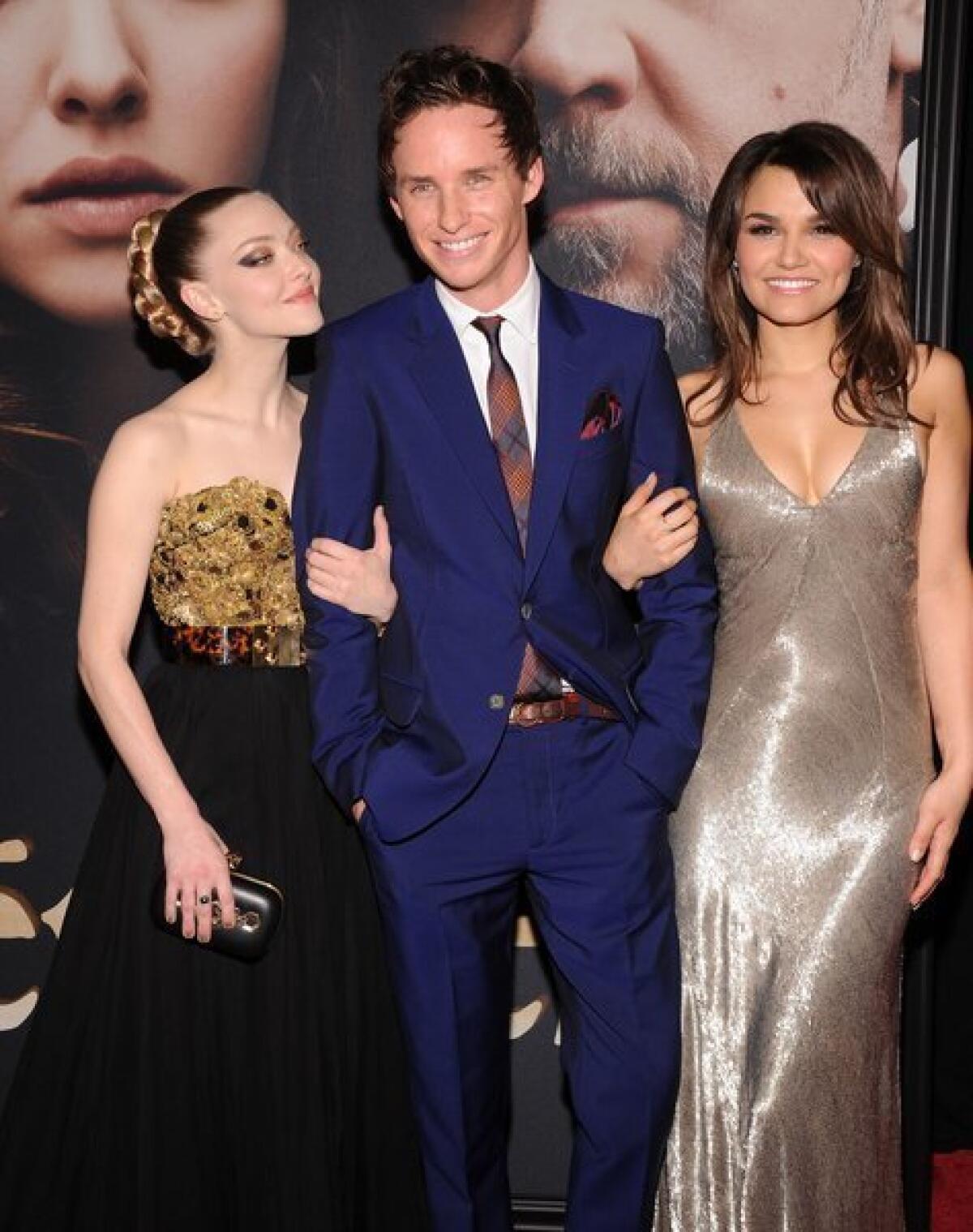 Amanda Seyfried, left, Eddie Redmayne and Samantha Barks attend the premiere of "Les Miserables" at the Ziegfeld Theatre on Monday in New York.