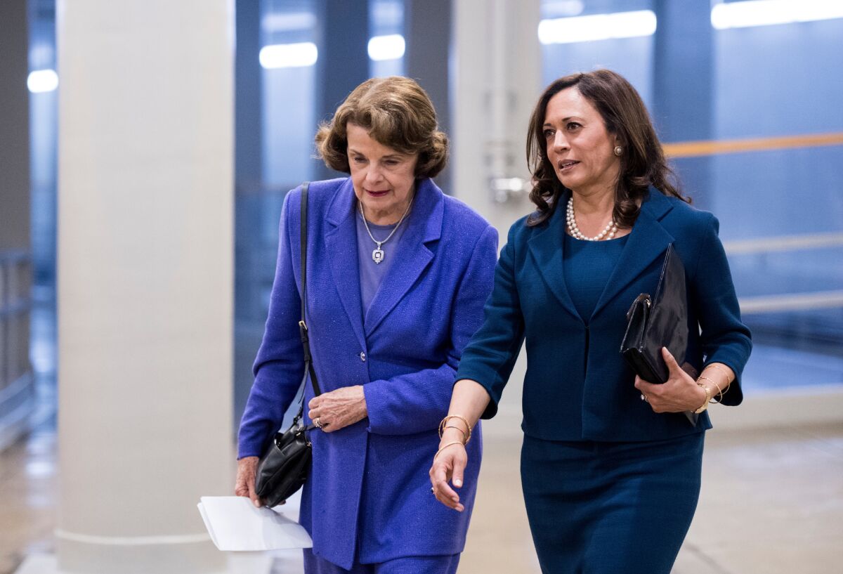 Sens. Dianne Feinstein, left, and Kamala Harris talk as they arrive in the Capitol for a vote in September 2017.