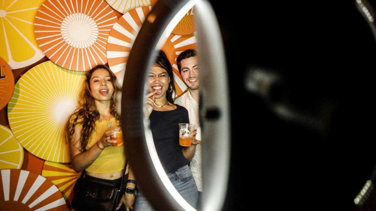 Los Angeles foodies, from left, Ilene Strudevant, Ashley Nunn and Tanner Pfaff pose in front of a GIF maker.