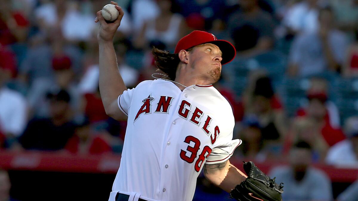 Angels starter Jered Weaver delivers a pitch during the first inning of Monday's win over the Toronto Blue Jays. Weaver left the game after the second inning because of tightness in his back.