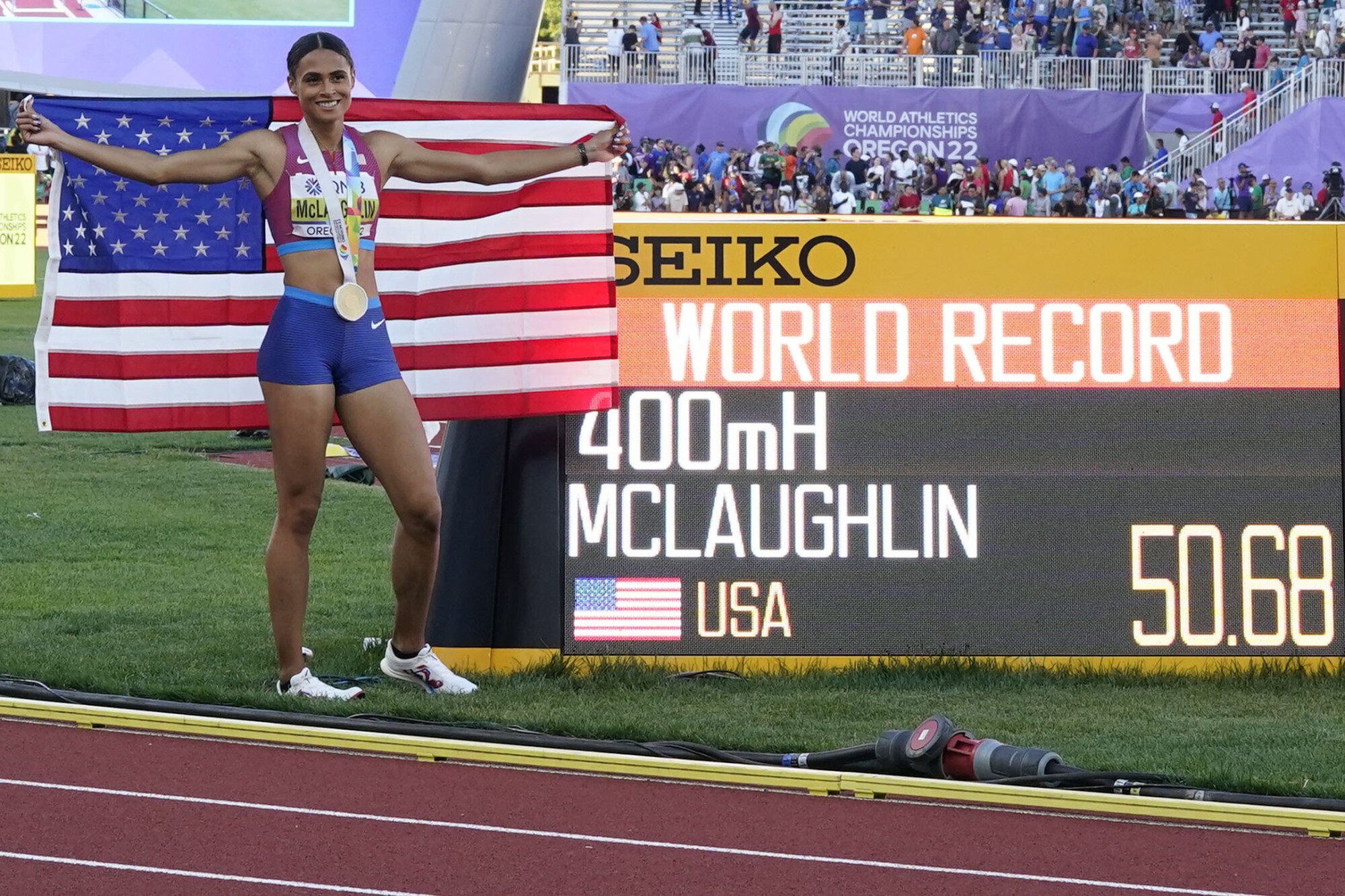 Gold medalist Sydney Mclaughlin celebrates her world-record time in the women's 400-meter hurdles.