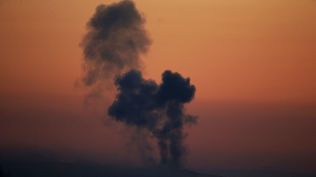 Plumes of smoke rise on the air from inside Syria as seen from the outskirts of the border town of Kilis, Turkey on Jan. 20.