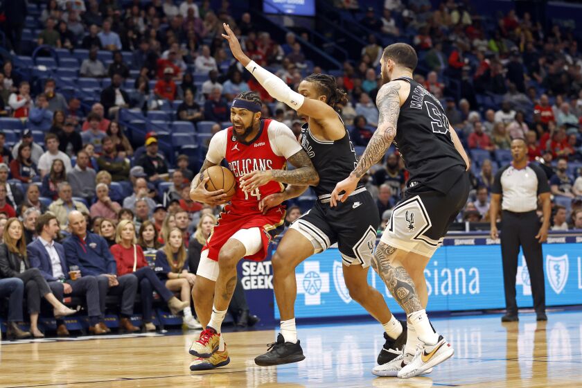 New Orleans Pelicans forward Brandon Ingram (14) drives past San Antonio Spurs guard Romeo Langford (35) in the first half of an NBA basketball game in New Orleans, Tuesday, March 21, 2023. (AP Photo/Tyler Kaufman)