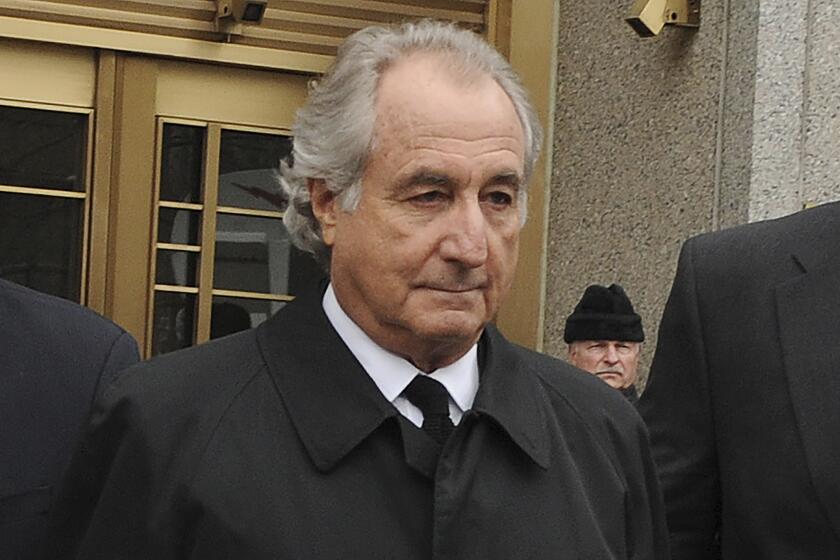 FILE - Bernard Madoff exits Manhattan federal court, Tuesday, March 10, 2009, in New York. Madoff, the financier who pleaded guilty to orchestrating the largest Ponzi scheme in history, died early Wednesday, April 14, 2021, in a federal prison, a person familiar with the matter told The Associated Press. (AP Photo/ Louis Lanzano, File)