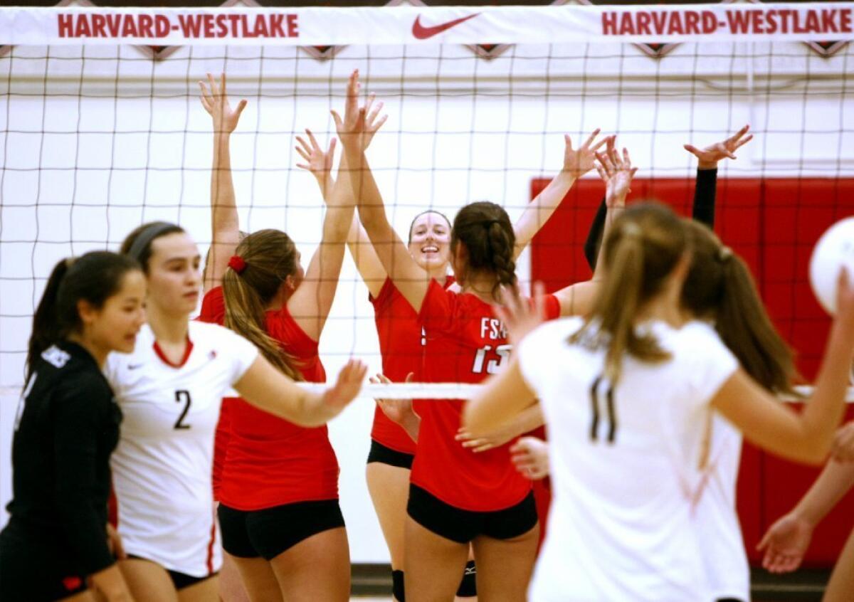 Flintridge Sacred Heart Academy's volleyball team celebrates a point during its sweep of Harvard-Westlake on Saturday.