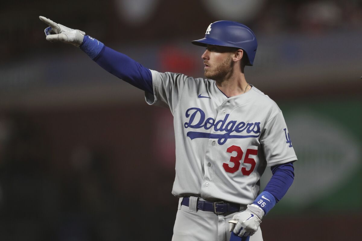 Los Angeles Dodgers' Cody Bellinger gestures after hitting an RBI-single against the San Francisco Giants during the ninth inning of Game 5 of a baseball National League Division Series Thursday, Oct. 14, 2021, in San Francisco. (AP Photo/Jed Jacobsohn)