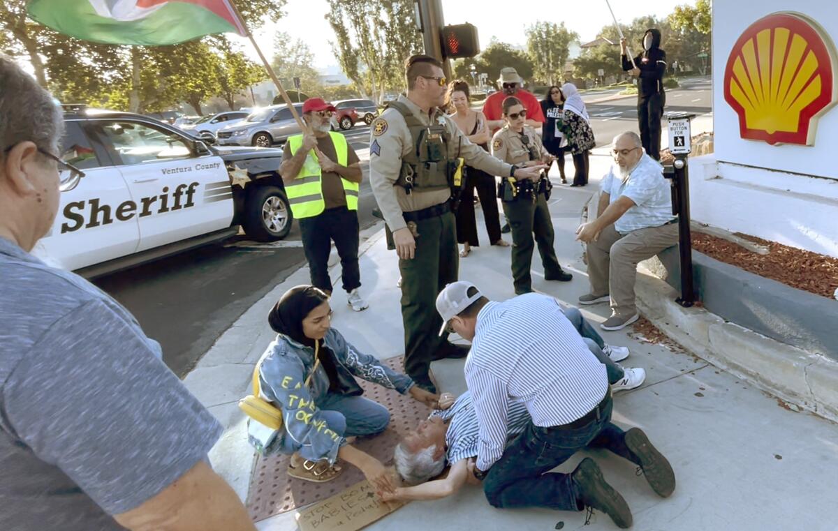 A man receives medical aid after suffering a head injury at a Thousand Oaks protest.