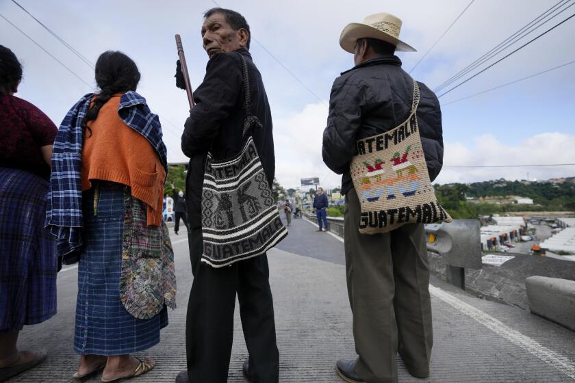 People block a road to demand the resignation of Attorney General Consuelo Porras and prosecutor Rafael Curruchiche in Guatemala City, Monday, Oct. 2, 2023. Indigenous organizations are blocking some roads across the country to protest the latest raids on Guatemala’s top electoral tribunal by the attorney general, after elections. (AP Photo/Moises Castillo)