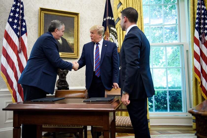 US President Donald Trump (C) shakes Guatemala's Interior Minister Enrique Degenhart (L) hand as acting US Secretary of Homeland Security Kevin K. McAleenan (R) watches after a safe-third agreement was signed, regarding people seeking asylum while passing through Guatemala, in the Oval Office of the White House on July 26, 2019 in Washington, DC. (Photo by Brendan Smialowski / AFP)BRENDAN SMIALOWSKI/AFP/Getty Images ** OUTS - ELSENT, FPG, CM - OUTS * NM, PH, VA if sourced by CT, LA or MoD **