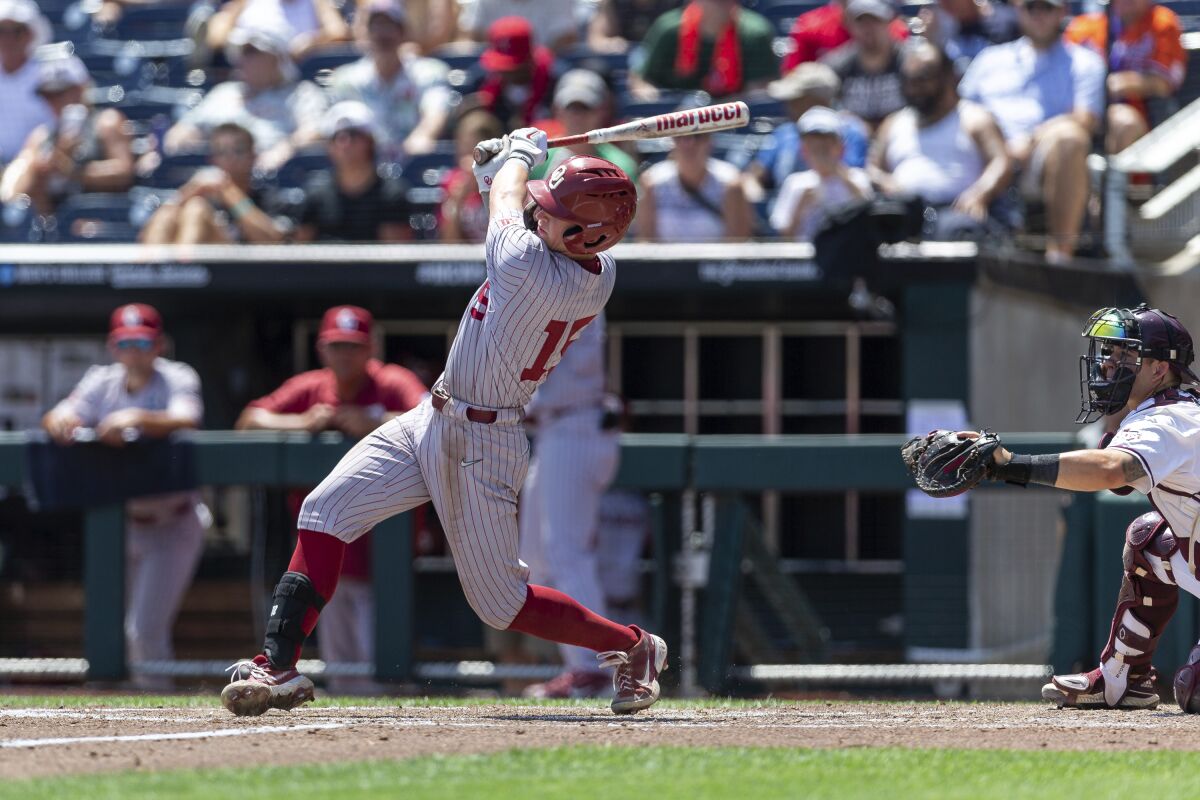 Oklahoma's Jackson Nicklaus (15) hits a grand slam in the fourth inning against Texas A&M during an NCAA College World Series baseball game Friday, June 17, 2022, in Omaha, Neb. (AP Photo/John Peterson)