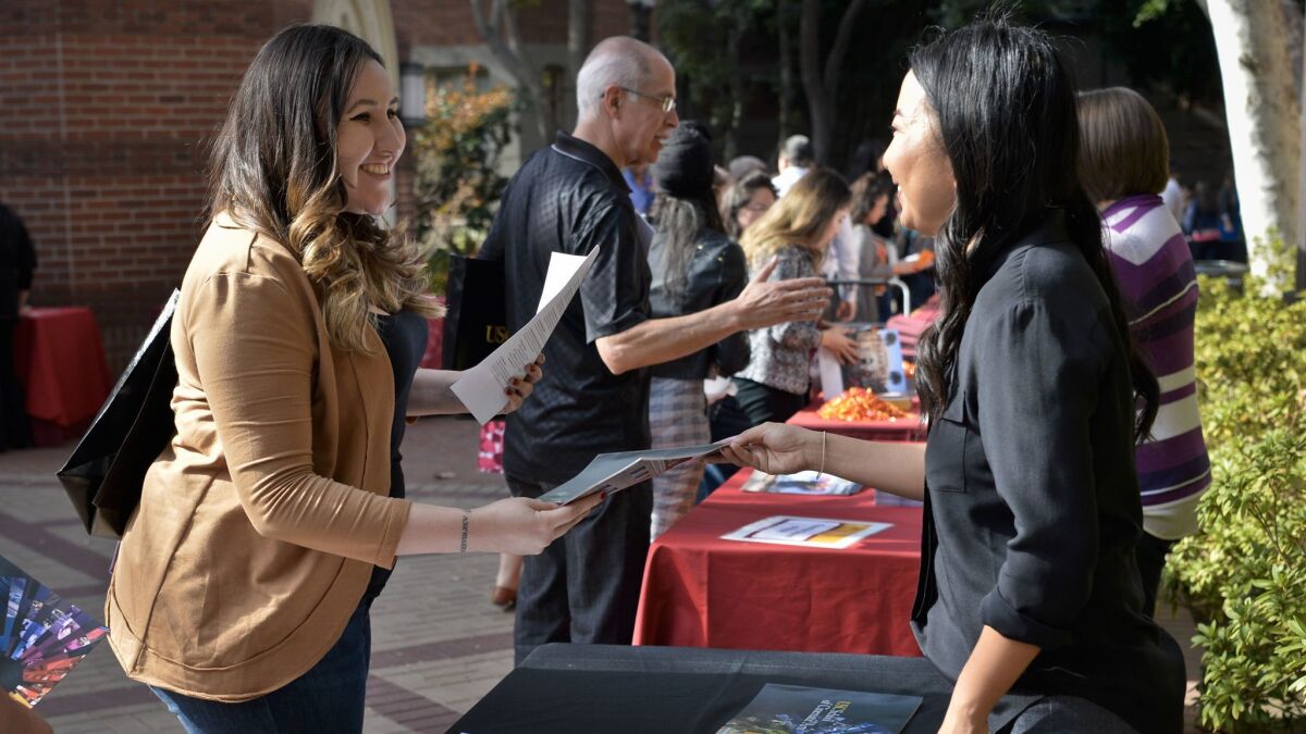 Natasha Marano, left, counselor at Cerritos College, talks with Susan Park, director of admissions for the USC School of Cinematic Arts, at an information fair for community college advisors at USC.