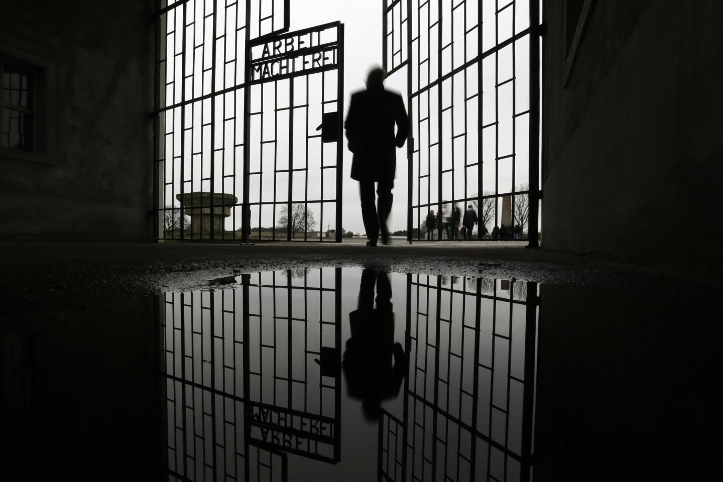 A man enters the Sachsenhausen Nazi death camp through the gate with the phrase "Arbeit macht frei" ("work sets you free") in Oranienburg, Germany. International Holocaust Remembrance Day marks the liberation of the Auschwitz Nazi death camp on Jan. 27, 1945.