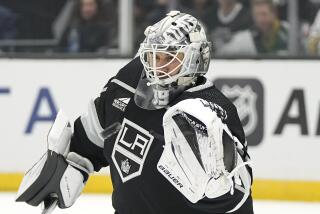 Los Angeles Kings goaltender Cam Talbot makes a glove save during the first period.