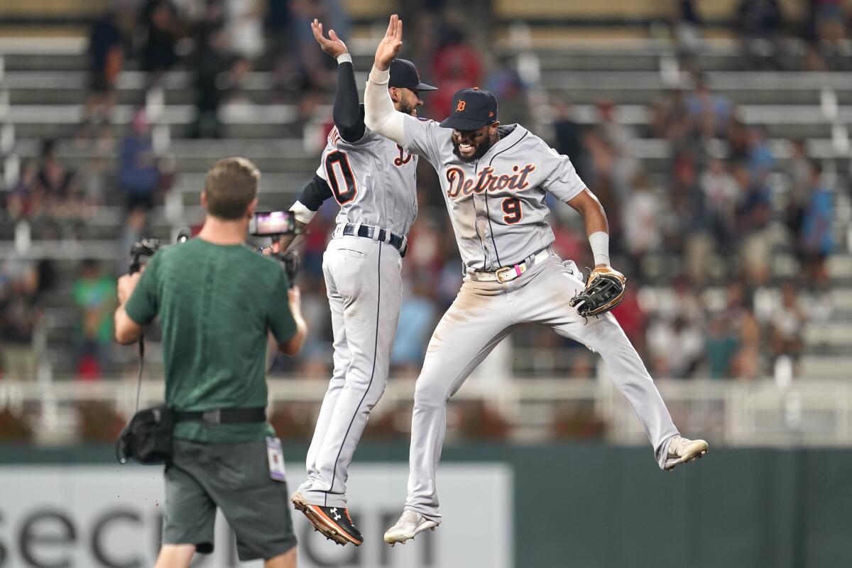 Detroit Tigers' Harold Castro, left, and left fielder Willi Castro, right, celebrate the team's 5-3 win in a baseball game against the Minnesota Twins on Tuesday, Aug. 2, 2022, in Minneapolis. (AP Photo/Abbie Parr)