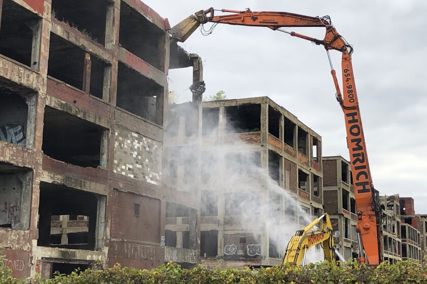 A demolition claw begins razing part of the long-vacant Packard auto plant on Thursday, Sept. 29, 2022, in Detroit. (AP Photos/Corey Williams)