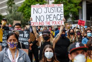 LOS ANGELES, CA - JUNE 05: A man holds up a sign with the words "Prosecute Killer Cops, No Justice No, No Peace, Defund the Police," along with about 1,000 people gathered to protest the death of George Floyd and in support of Black Lives Matter, in downtown, Los Angeles, CA, on Friday, June 5, 2020. (Jay L. Clendenin / Los Angeles Times)