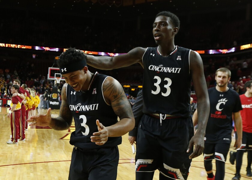 Cincinnati guard Justin Jenifer (3) celebrates with teammate Nysier Brooks (33) after defeating the Iowa State Cyclones on Dec. 1.