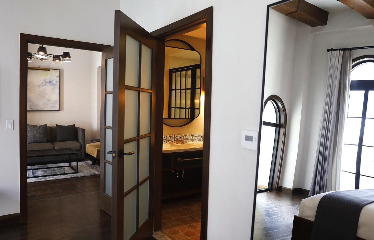 The mirror facing the window helps bring light in a guest room at Hotel Figueroa.