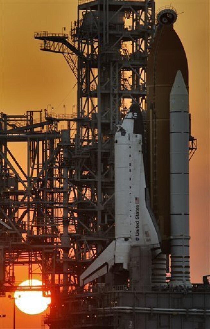 The sun sets on the space shuttle Atlantis Sunday May 10, 2009 at the Kennedy Space Center in Cape Canaveral, Fla. With a forecast of near-perfect weather, NASA's Hubble Space Telescope scientists and managers were euphoric as they awaited Monday's planned launch of shuttle Atlantis on the final trip to the orbiting observatory. (AP Photo/Chris O'Meara)