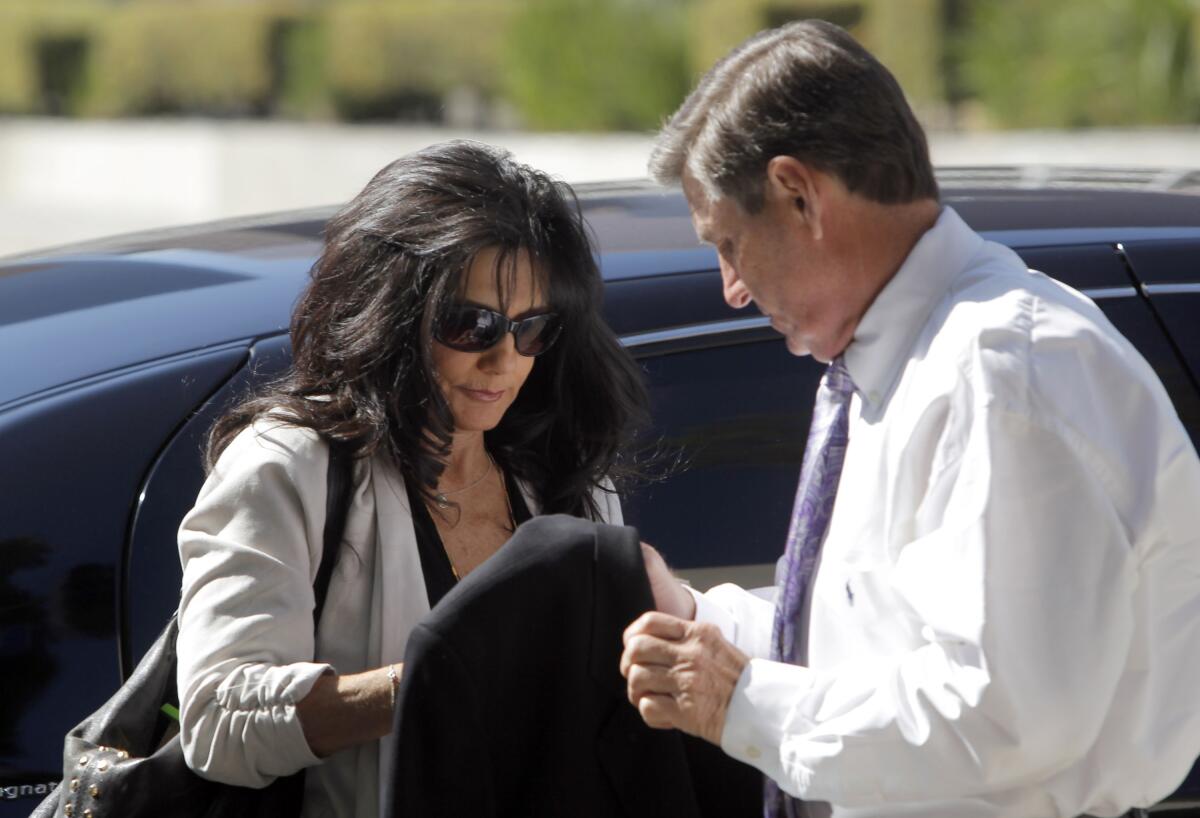  A man and a woman outside a shiny black car