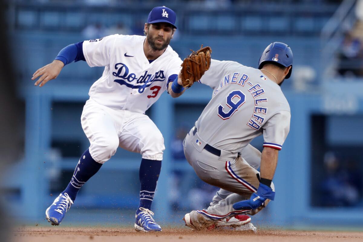 Texas baserunner Isiah Kiner-Falefa, right, steals second base in front of shortstop Chris Taylor on Saturday.