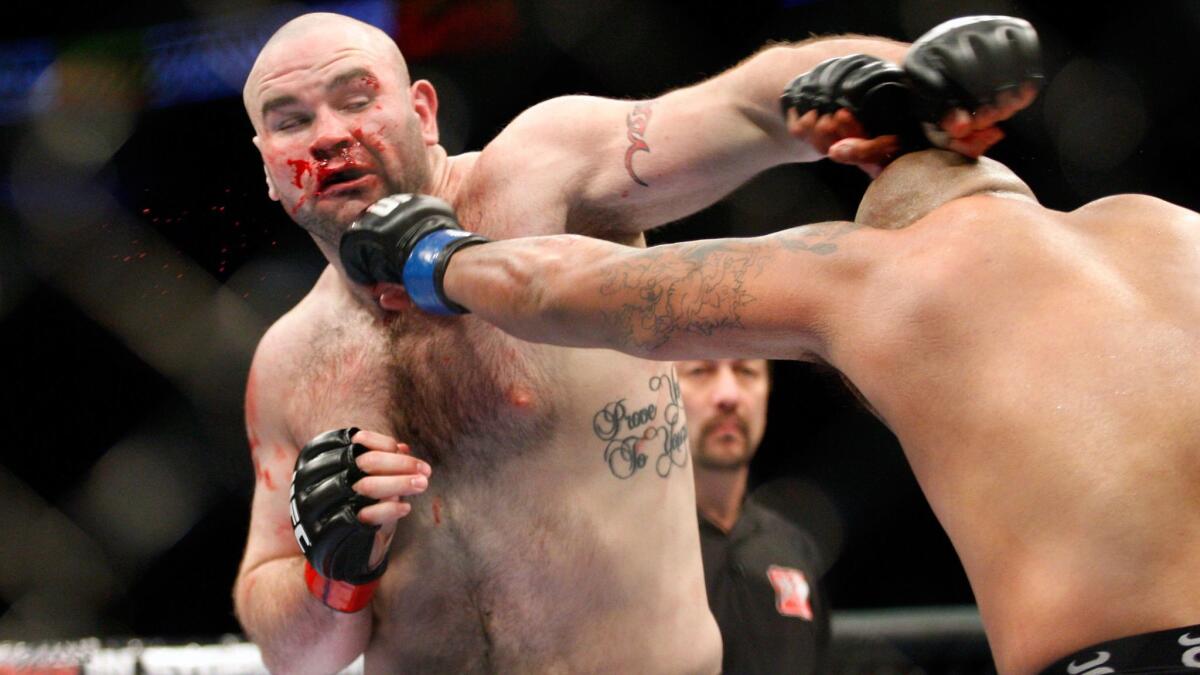 Tim Hague, left, takes a punch from Joey Beltran during their heavyweight bout at UFC 113 on May 8, 2010.