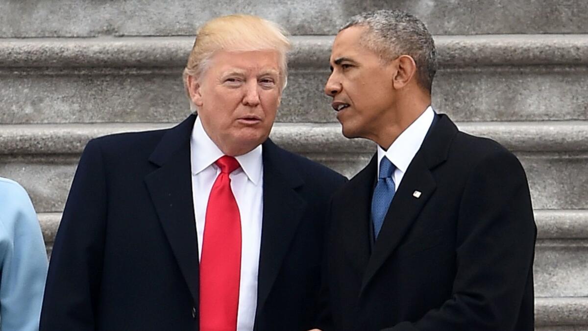 Presidents Trump and Obama talk at the former's inauguration ceremony on Jan. 20, 2017.