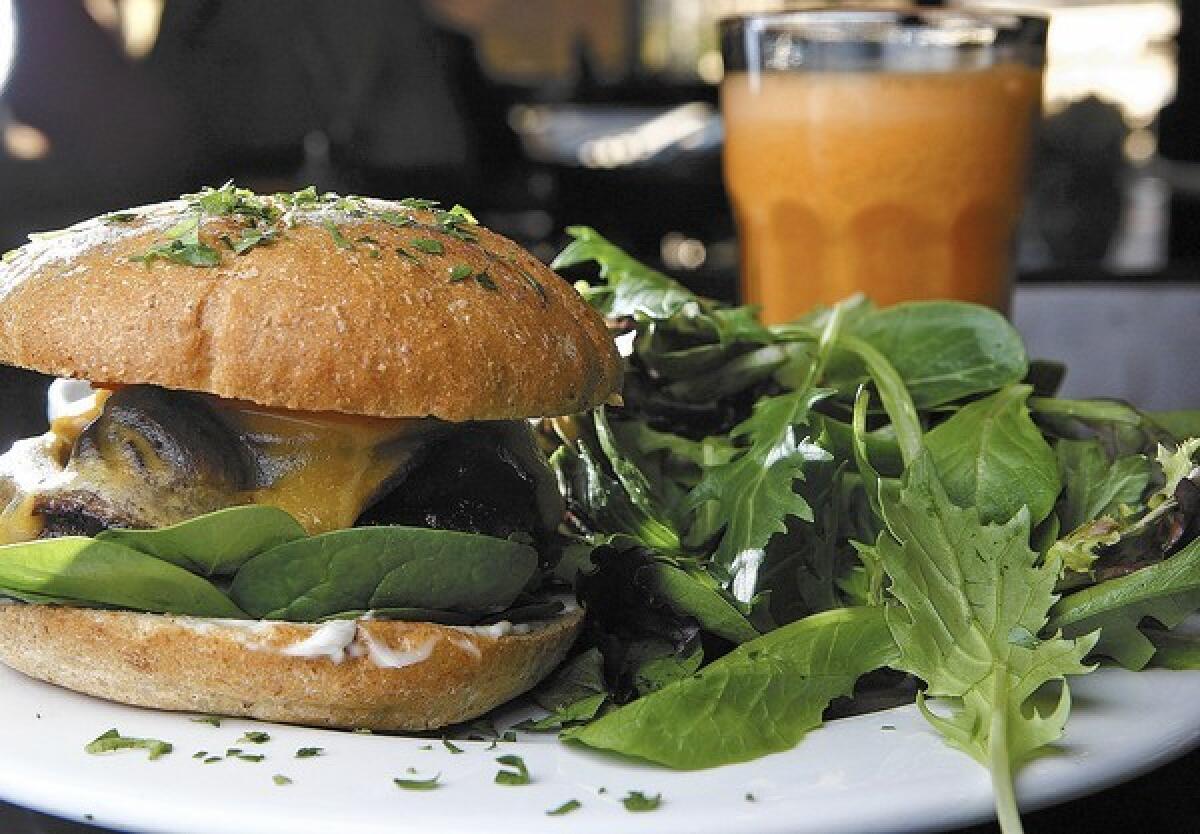 Burger with a ground patty of beef, turkey or chicken breast, tomato, spinach, grilled onion, sauted mushrooms and cheddar cheese at Green Corner Cafe in Glendale on Thursday, Dec. 5, 2013. The restaurant specializes in organic, non-GMO and gluten-free food.