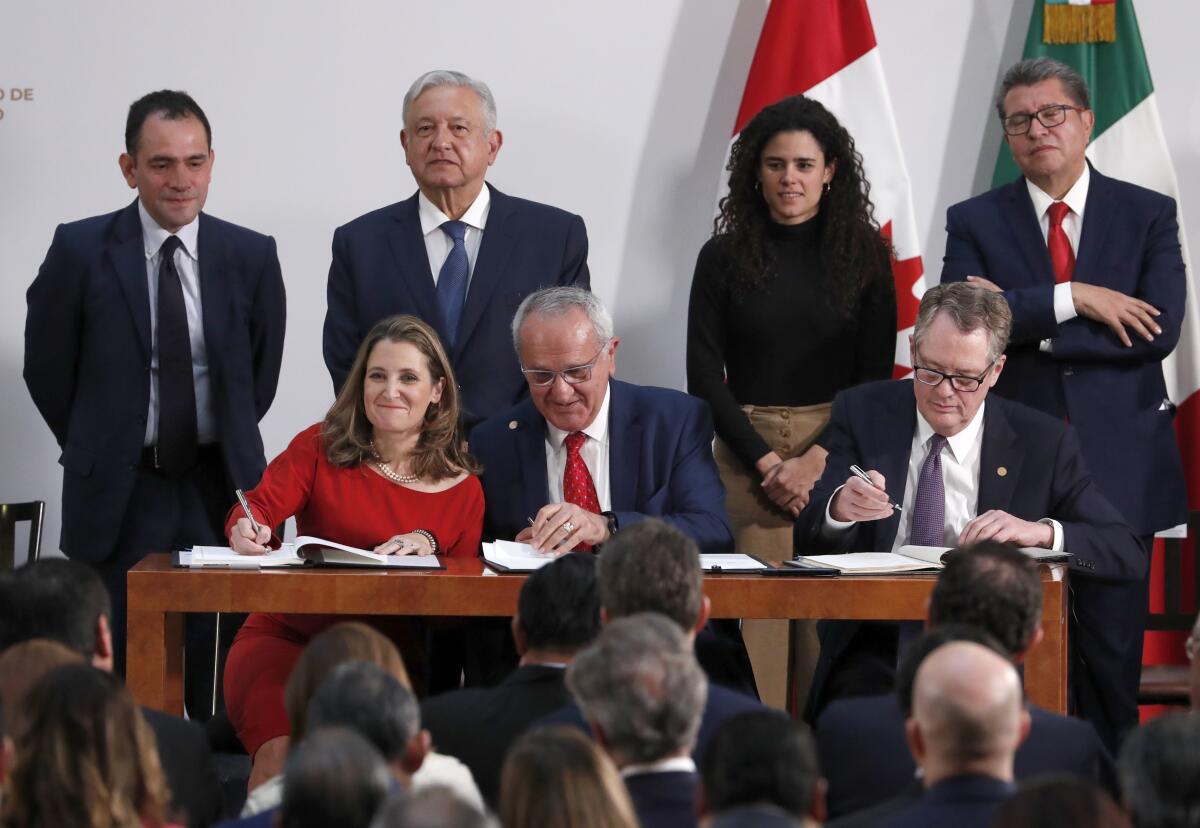 Deputy Prime Minister of Canada Chrystia Freeland, Mexico's top trade negotiator Jesus Seade, and U.S. Trade Representative Robert Lighthizer, sign an update to the North American Free Trade Agreement