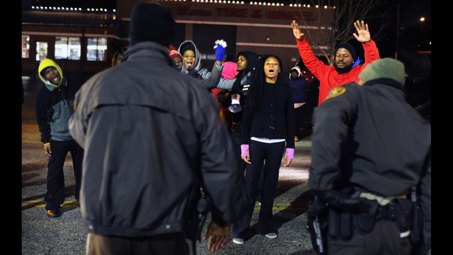 Protesters shout at police officers outside the Ferguson police station on Nov. 20.