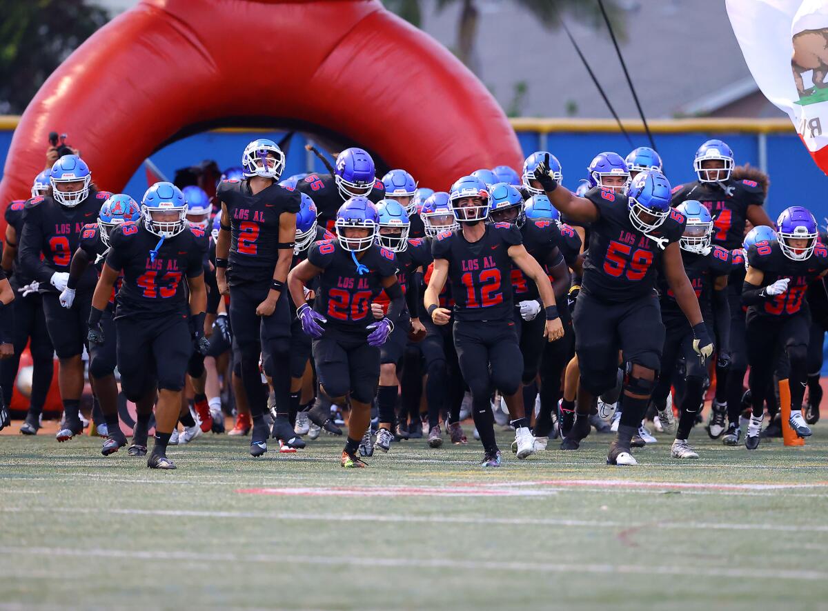 Los Alamitos players take the field.