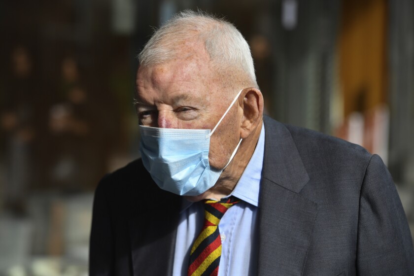 Ron Brierley leaves the Downing Centre District Court in Sydney, Australia, April 1, 2021. The well-known New Zealand businessman who was found with hundreds of child sex abuse images gave up his knighthood Tuesday, May 4, 2021, before it was stripped from him. (Mick Tsikas/AAP Image via AP)