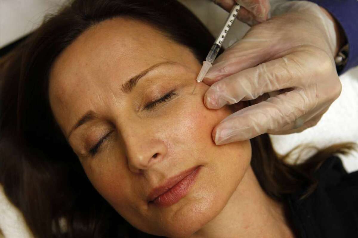 Colleen Delsack of Virginia receives a Botox injection. Valeant Pharmaceuticals International Inc. said it hopes to acquire Botox maker Allergan Inc., which is based in Irvine.