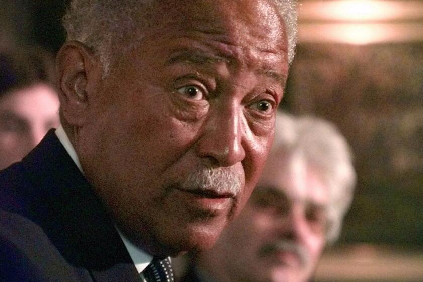 Former Mayor David Dinkins talks to reporters during a news conference Tuesday, April 7, 1998, in New York in which he invited current Mayor Rudolph Giuliani to dine at his home in an effort to patch up their feud. Dinkins defended the actions he took during the 1991 Crown Heights race riots and took a few shots at Giuliani, who publicly apologized last week for the city's and Dinkins' handling of the 1991 riots. (AP Photo/Kathy Willens)