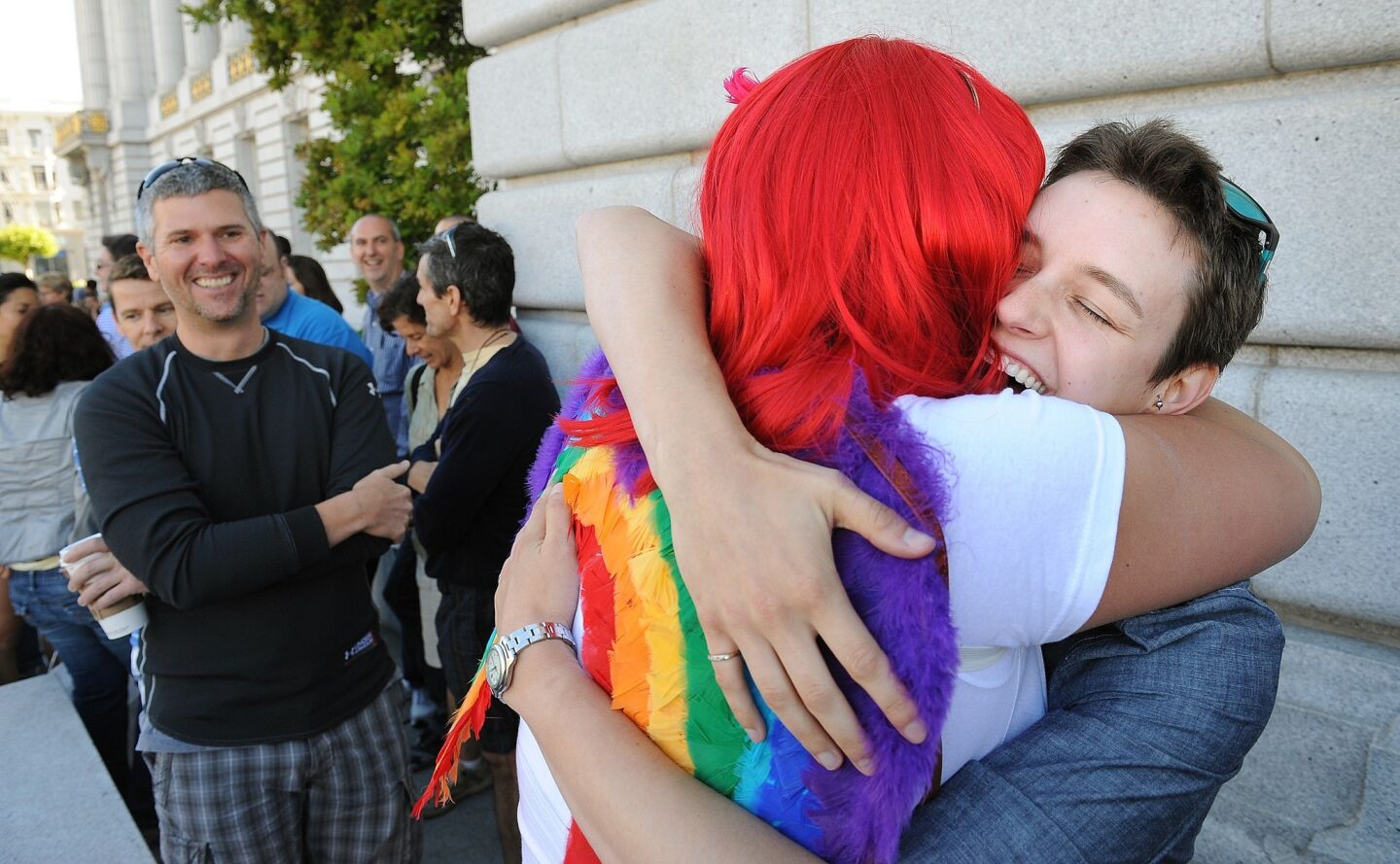 Brandie Yelland, left, hugs friend Erika Lewis in support of her marriage outside City Hall in San Francisco Saturday.