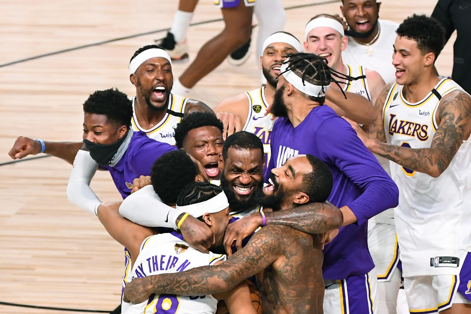 Laker players, including LeBron James, celebrate winning the NBA championship.
