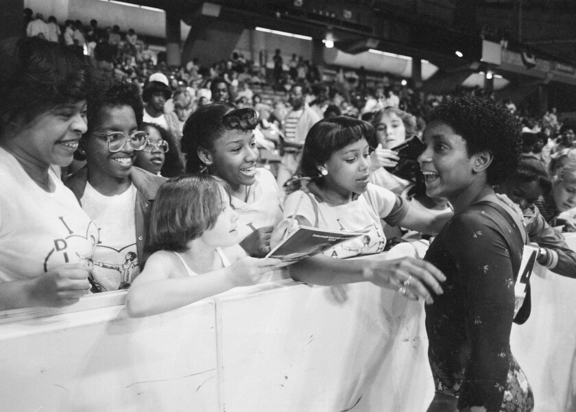 Dianne Durham, 15, of Gary, Ind., right, signs autographs after winning the women's title.