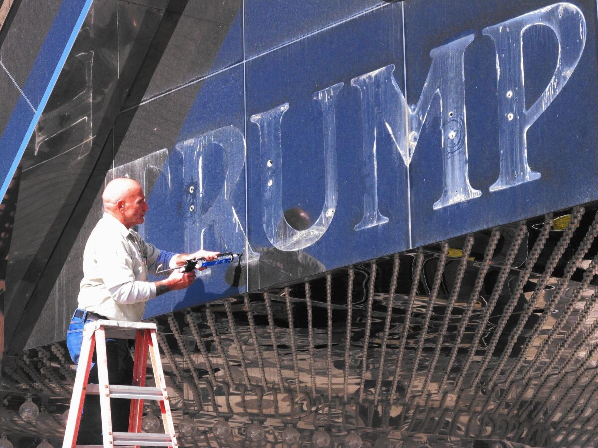 A sign is removed from the former Trump Plaza casino in Atlantic City, N.J., in October 2014. The casino closed the previous month.