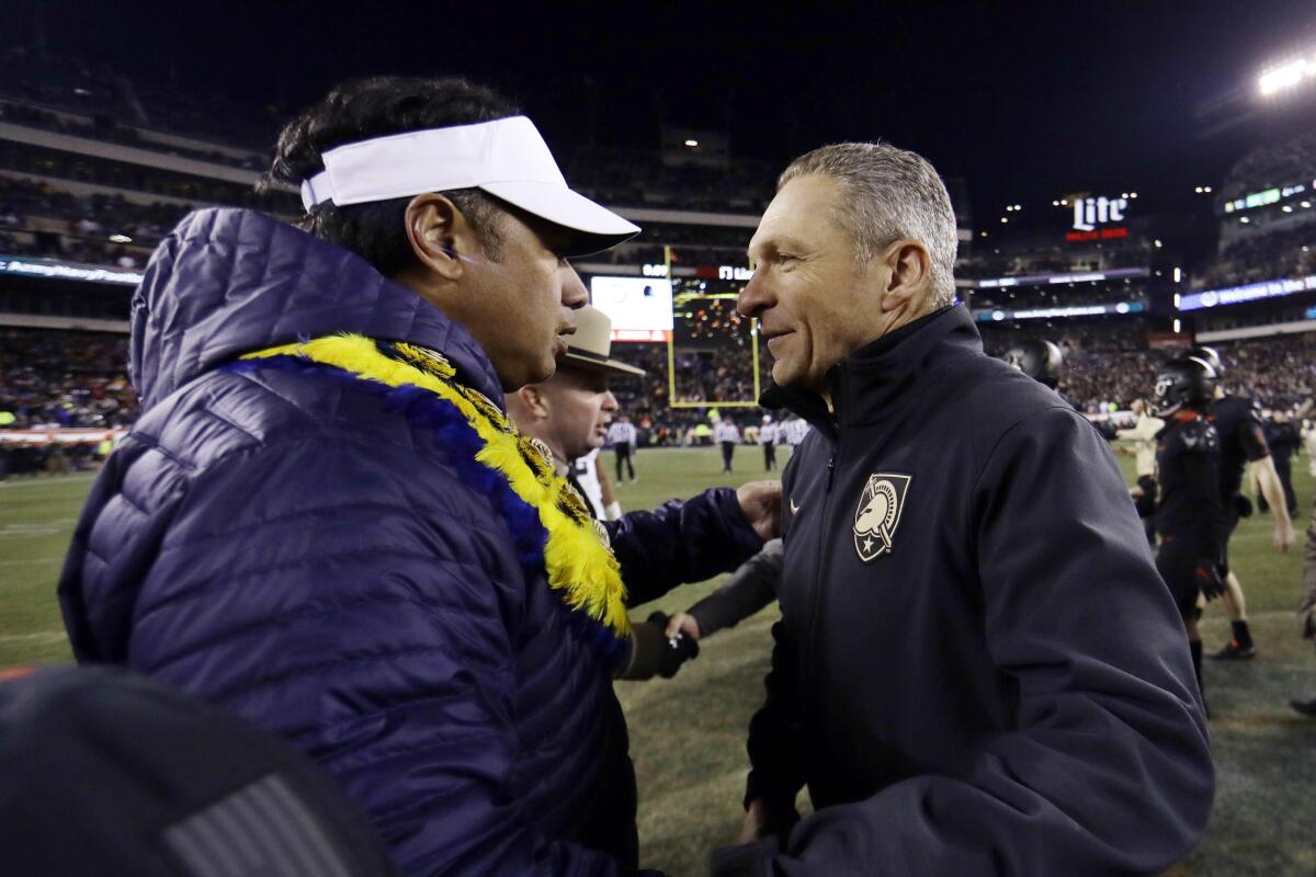 FILE - In this Dec. 8, 2018, file photo, Army head coach Jeff Monken, right, greets Navy head coach Ken Niumatalolo after an NCAA college football game in Philadelphia. Army and Navy play on Saturday, Dec. 10, 2022, for the 123rd time, the 90th time in Philadelphia and 14th time at Lincoln Financial Field, the home of the NFL-leading Philadelphia Eagles. (AP Photo/Matt Slocum, File)