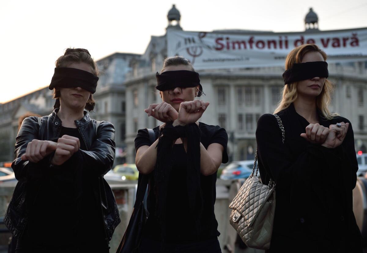 Romanian women in Bucharest show solidarity with Polish women protesting a proposed abortion law in Poland. (Daniel Mihailescu/AFP/Getty Images)
