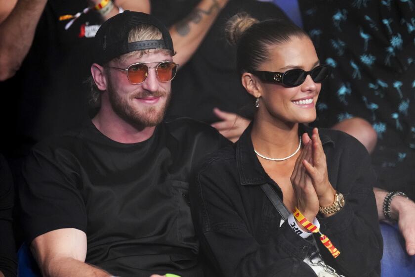 Logan Paul, left, and Nina Agdal are at UFC 284 at RAC Arena in Perth, Australia.