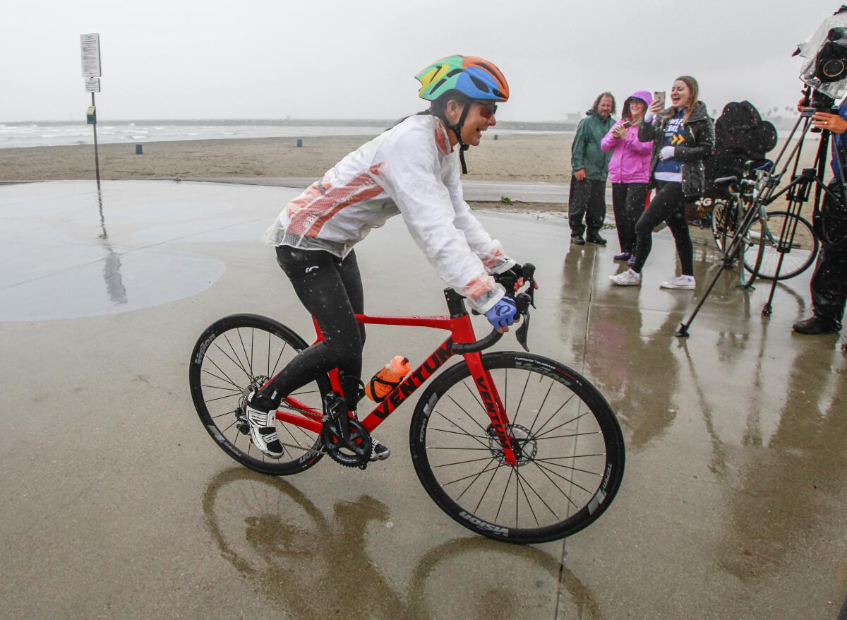 Along with supporters, Isabella de la Houssaye, a stage 4 cancer patient, begins her cross country bike ride in Ocean Beach on March 10, 2020 in San Diego, California. De la Houssaye, 56, is riding cross country to Jacksonville, FL to raise awareness for lung cancer research.