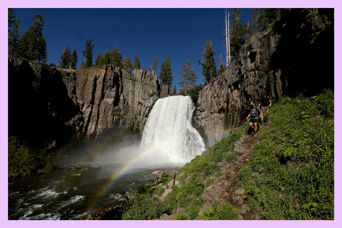 Hikers follow a trail along Rainbow Falls in the Devil's Postpile National Monument near Mammoth Lakes
