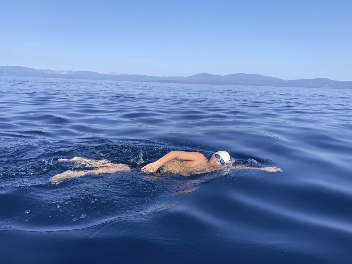 This Aug. 1, 2021 image provided by Jillian Savage shows James Savage, 14, of Los Banos, Calif. as he swam the entire 21.3-mile length of Lake Tahoe from South Lake Tahoe, California to Incline Village, Nevada. He became the youngest person ever to make the swim and complete the coveted Tahoe Triple Crown. He completed the two other legs of the triple crown earlier, each 10 miles are longer. (AP Photo/By Jillian Savage)