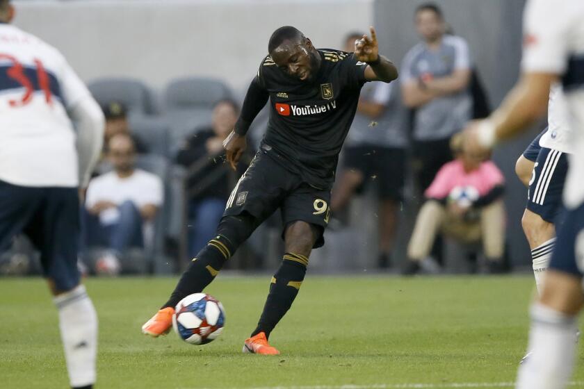 Los Angeles FC forward Adama Diomand takes a shot against the Vancouver Whitecaps during the first half of a Major League Soccer game in Los Angeles, Saturday, July 6, 2019. (AP Photo/Alex Gallardo)